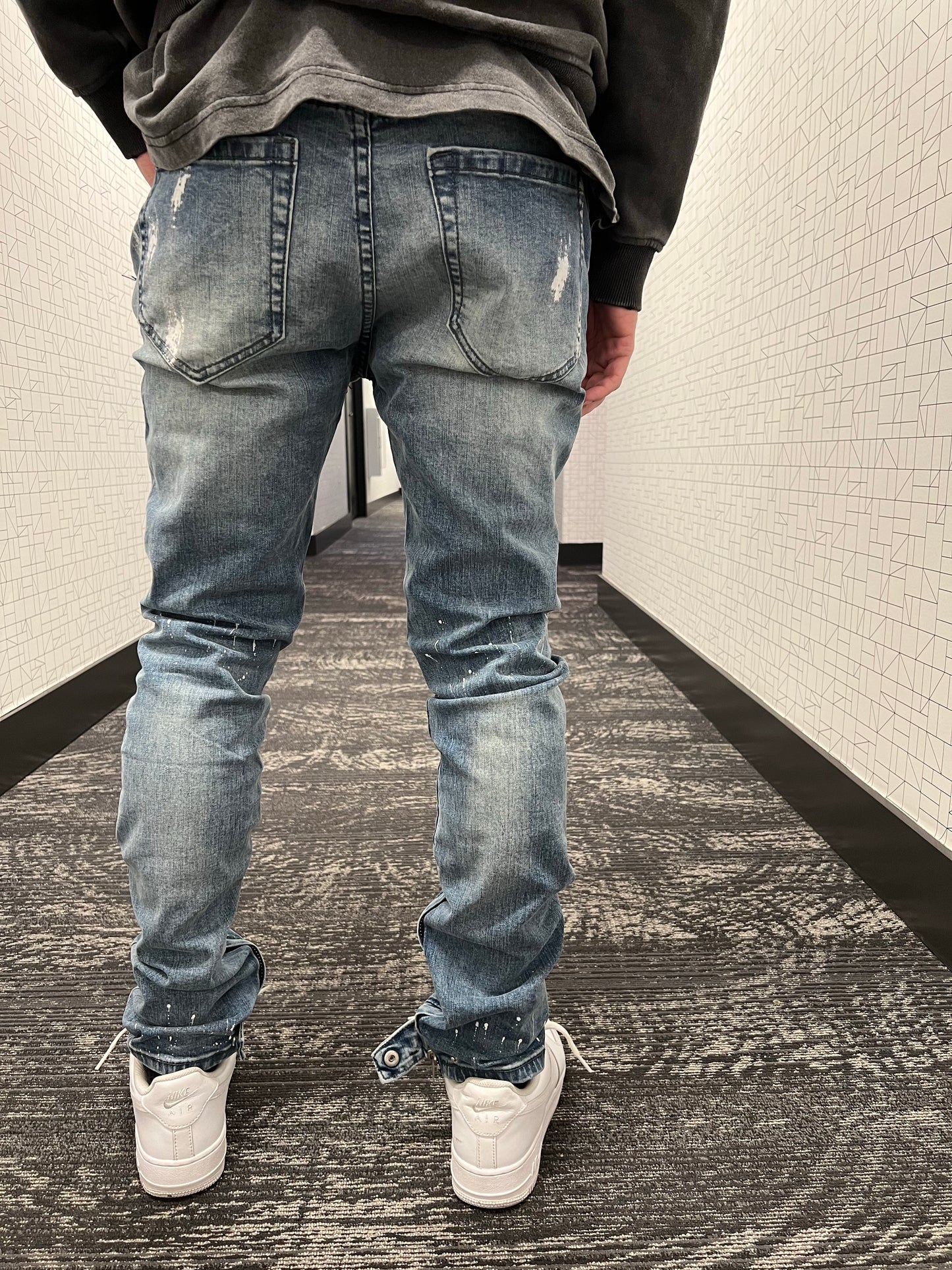 Blue distressed paint jeans