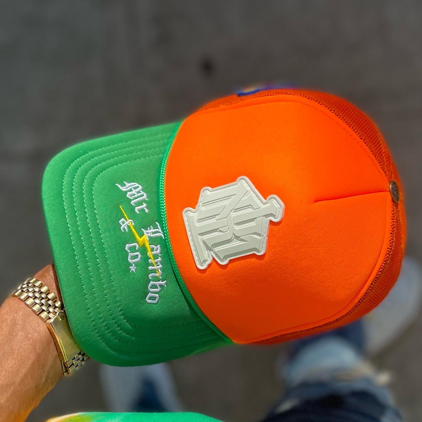 Orange and green trucker