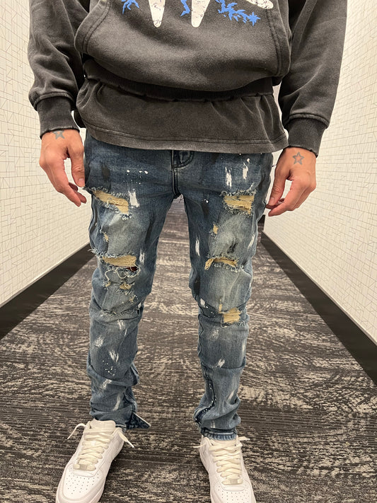 Blue distressed paint jeans