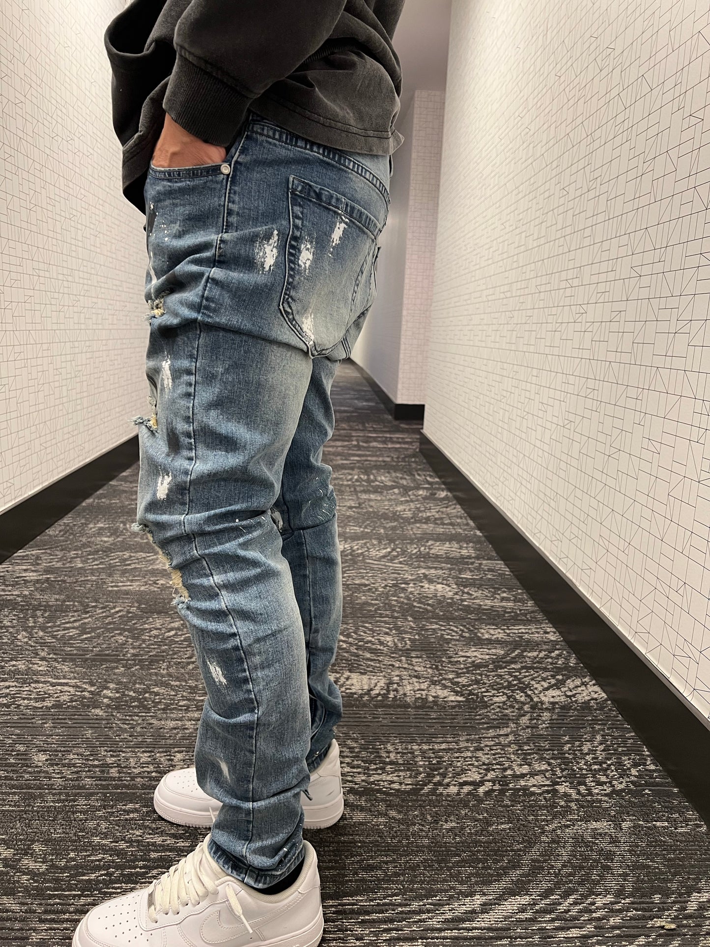 Blue distressed paint jeans