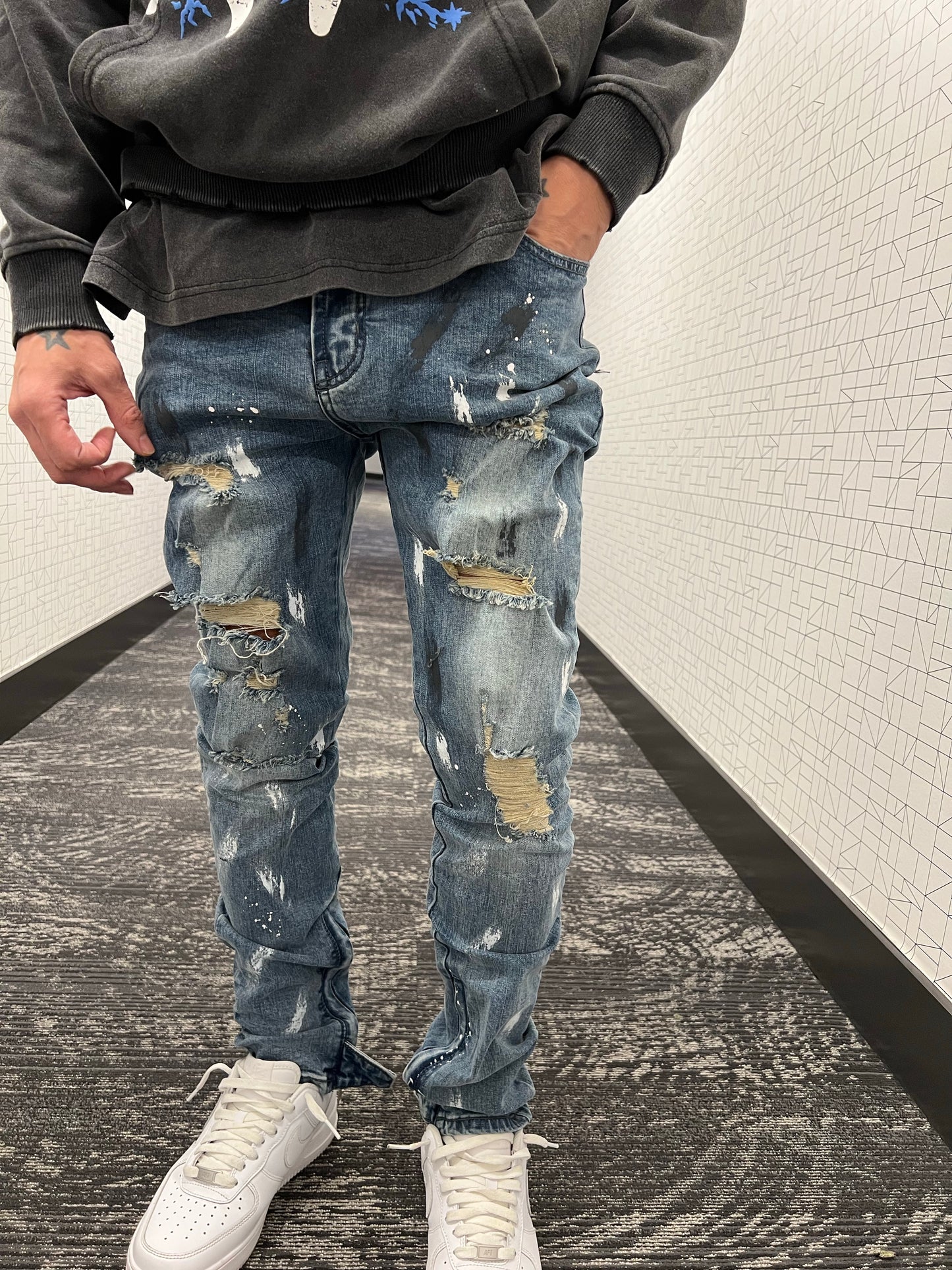Blue distressed paint jeans
